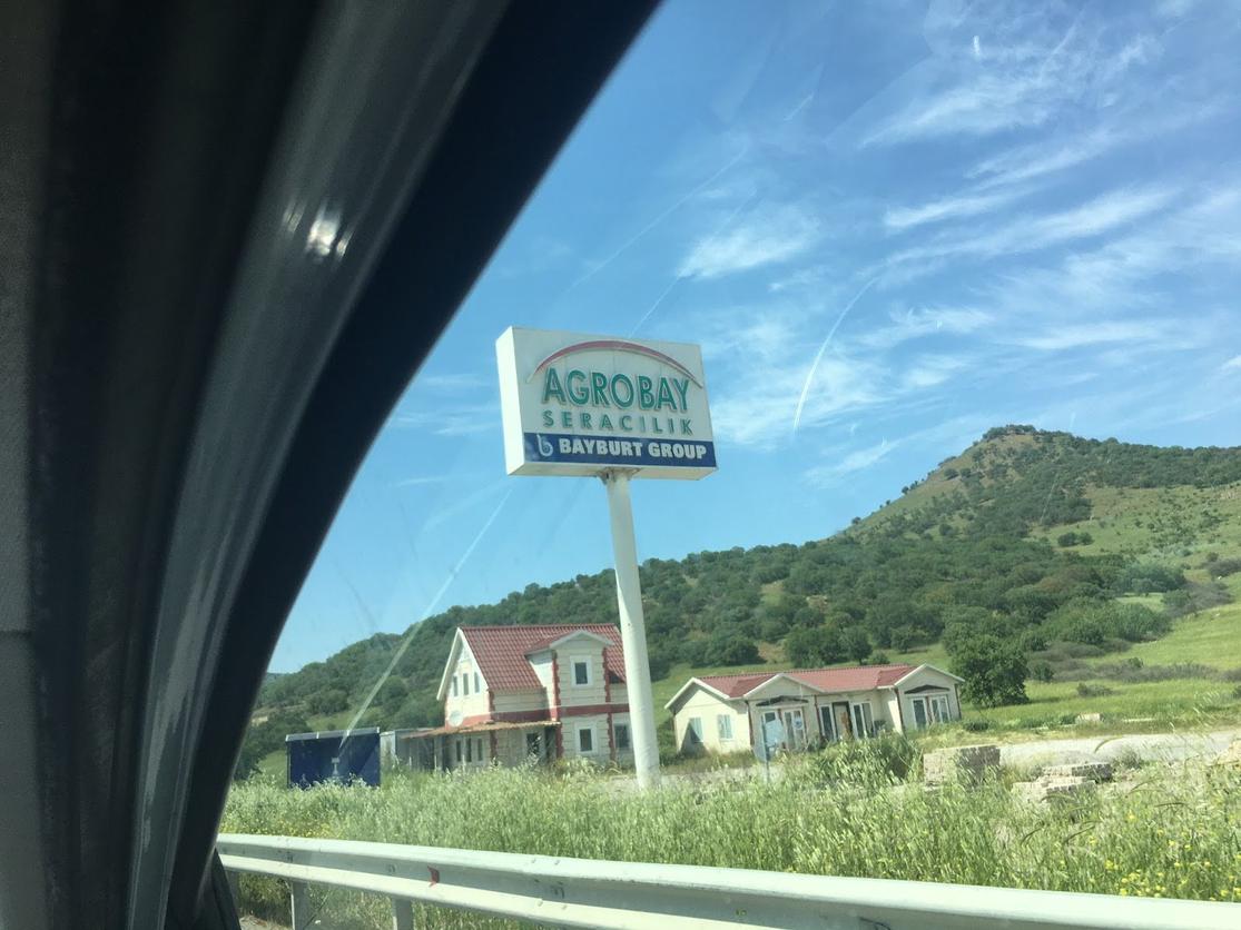 Agrobay sign on roadside with fields
